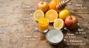 Nahaufnahme von frischem Ingwer Shot mit Orangen, Zitronen und Kokoswasser