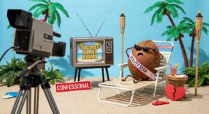 Symbolbild: Fernseher und Kokosnuss in tropischer TV-Show-Kulisse