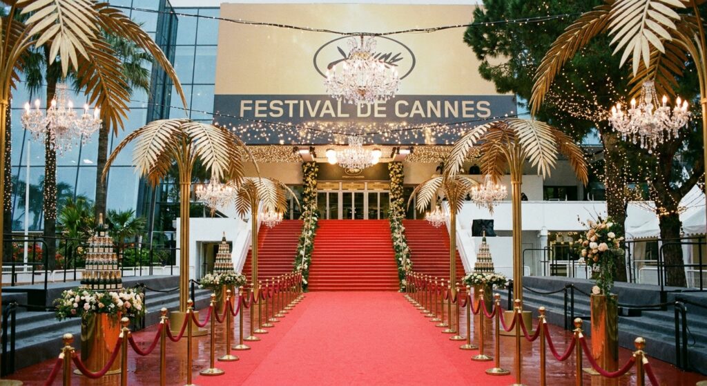 Symbolbild für das Cannes Filmfestival mit rotem Teppich und Glitzer